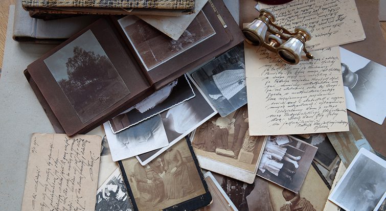 Various images and papers are scattered across a tabletop